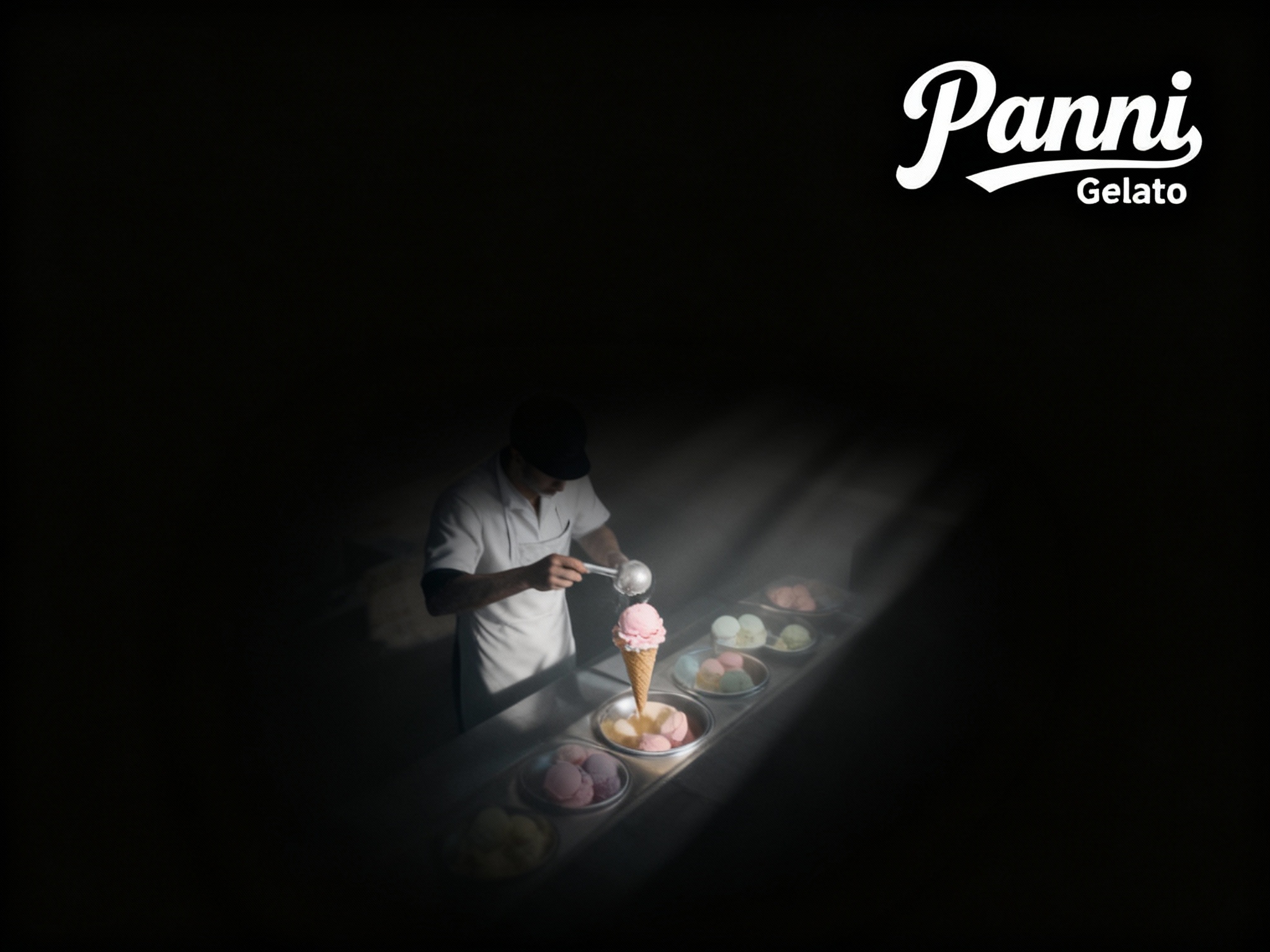 设计品牌宣传海报用主色 {主色} ，画面干净，（将参考图中的LOGO ）位于左上角或右上角（根据实际情况设置），大师作品，电影海报，超高质量，超精细，高级英文排版，摄影，丁达尔光效，朦胧，俯视，远景，极简，简单，极简风格，大面积留白，James Turrell，背景是冰淇淋师制作冰淇淋的景象，压迫感，超现实主义+极简主义 + 简单色块+ 马卡龙配色+ 摄影艺术 + 细节丰富+ 封面美学 +黑色背景+电影级照明，4k高清，排版简洁有视觉冲击力，符合社交平台分享特性。